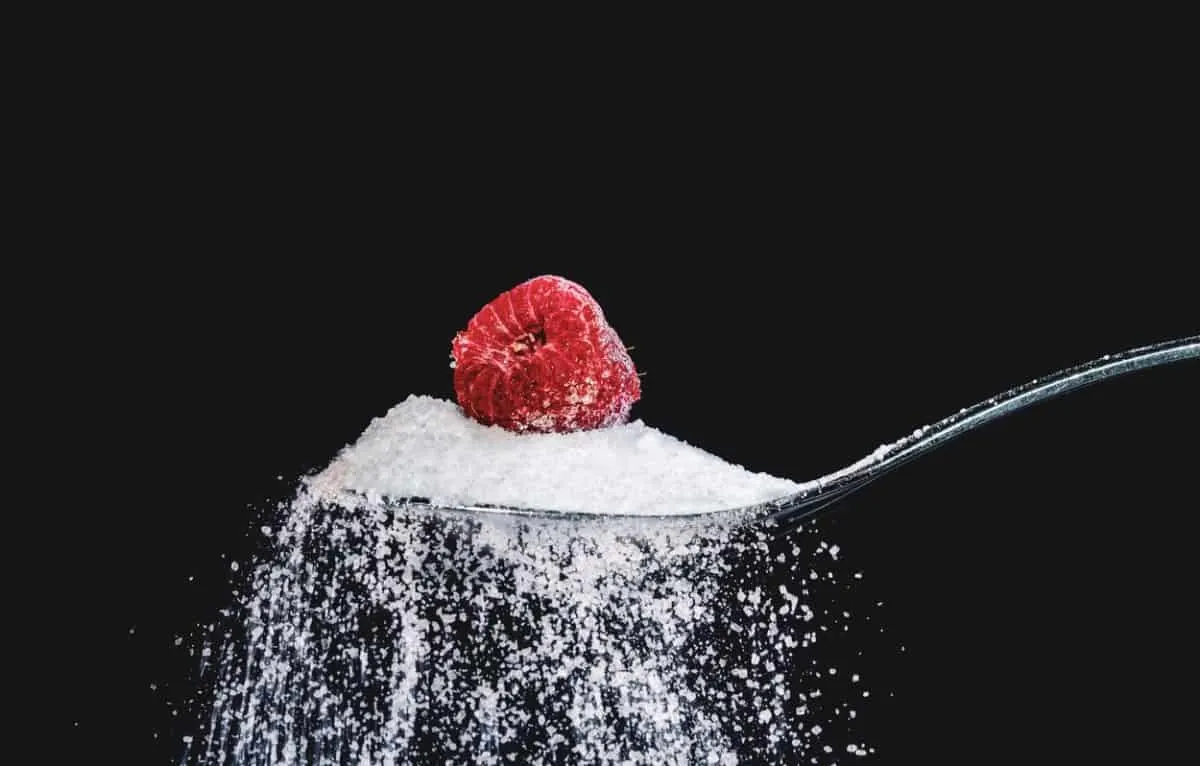 Teaspoon of sugar with a raspberry on top