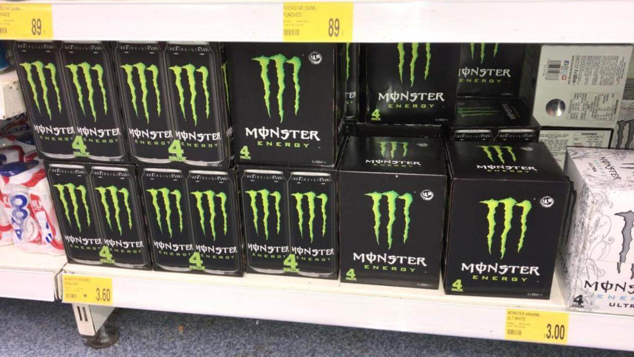 Boxes of Monster Energy Drinks on a shelf