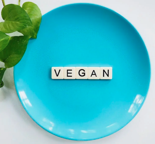 blue plate having vegan written on it