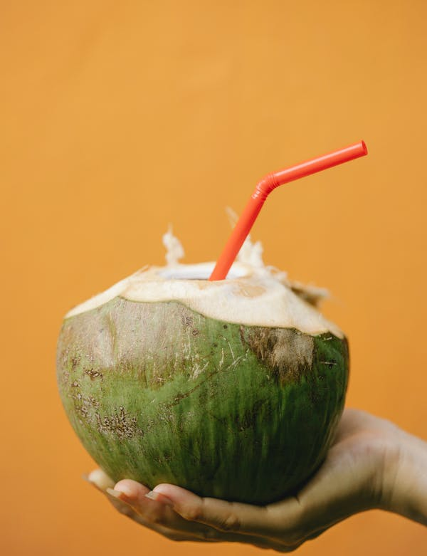 woman with a coconut cocktail
