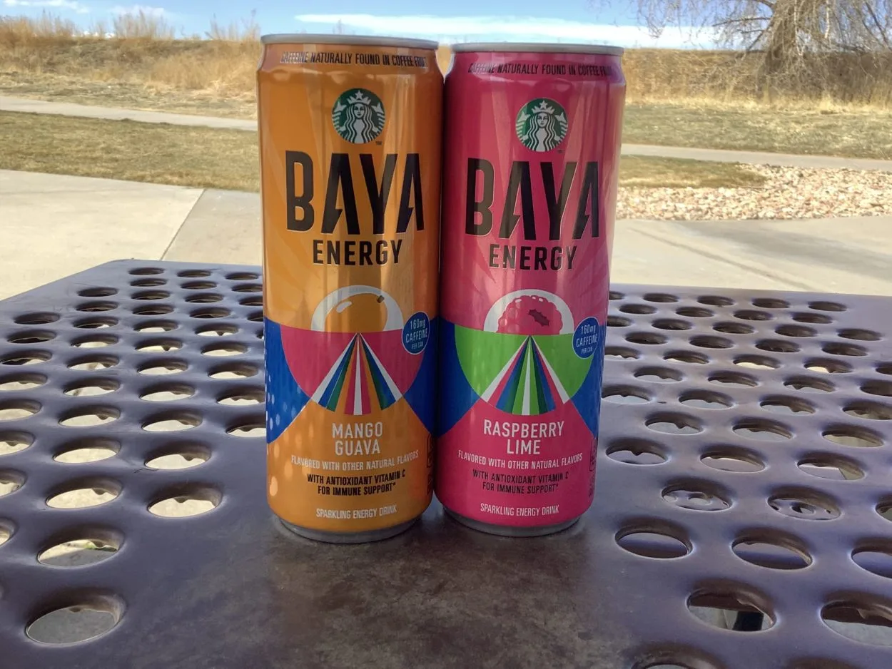 Two cans of baya energy in Mangi Guava and Raspberry lime flavor on a table