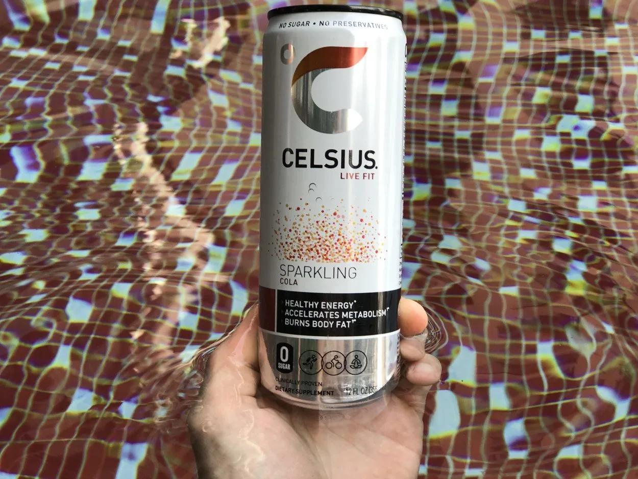 A man holding a can of Celsius Sparkling Cola