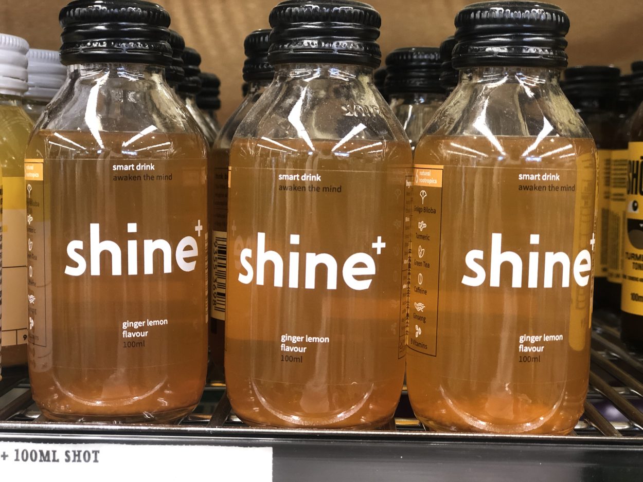 Three bottles of Shine in ginger lemon flavor