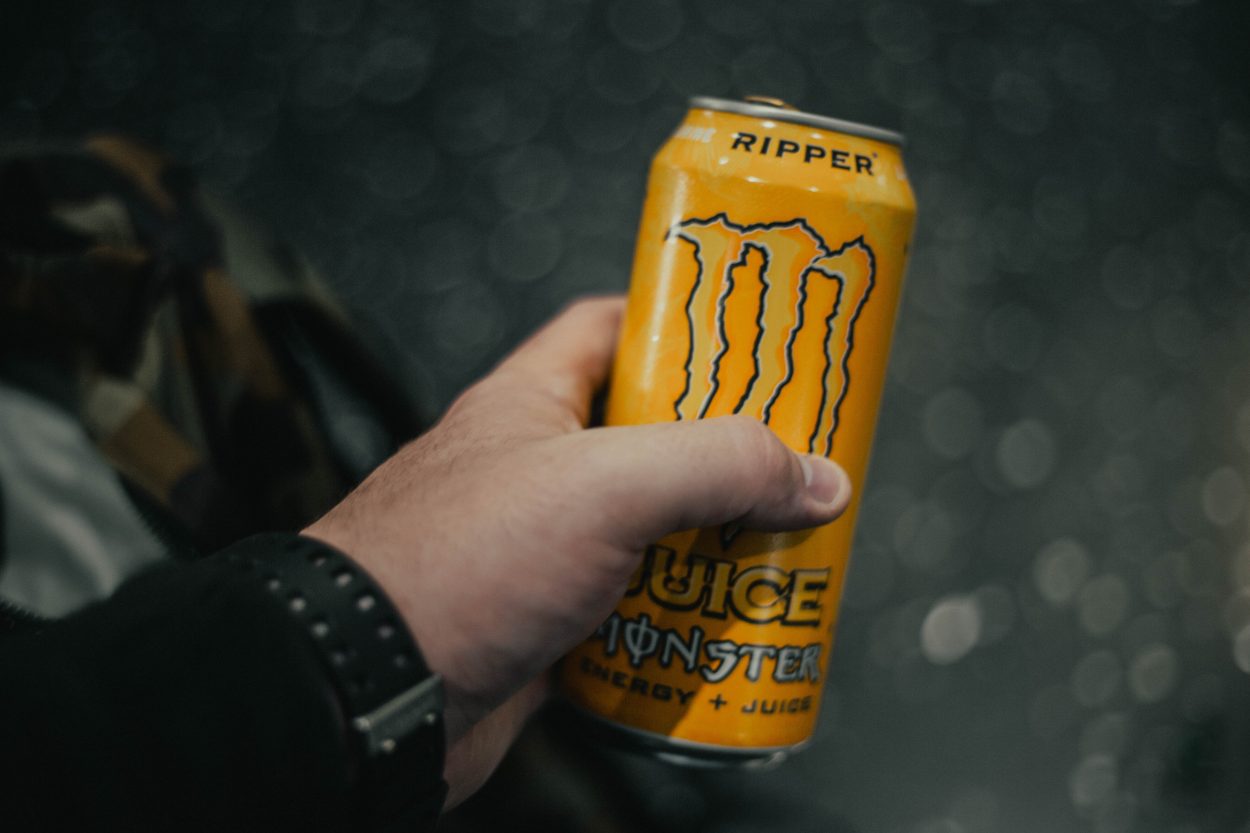 A man holding a can of Monster