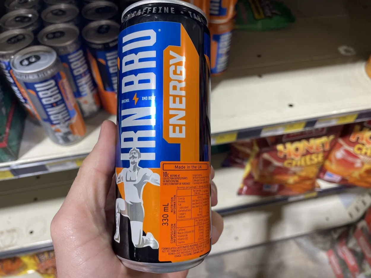 A person holding a can of Irn Bru