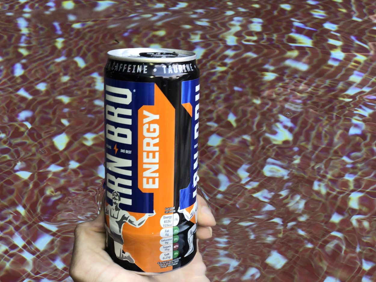 A person holding a can of Irn Bru