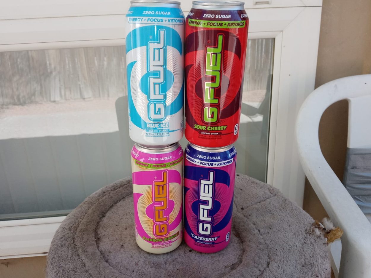 Four cans of G Fuel in different flavors