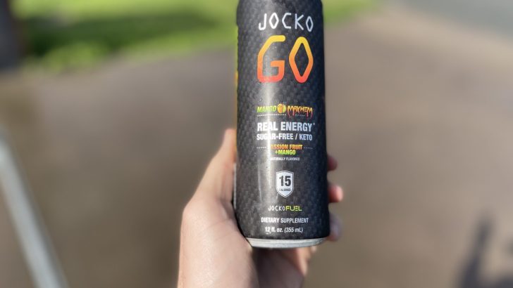 A persom holding a can of Jocko Go