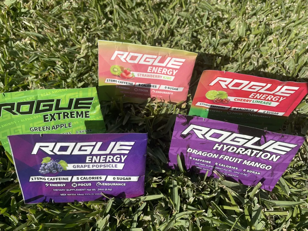 Sachets of Rogue Energy powder on the grass in different flavors