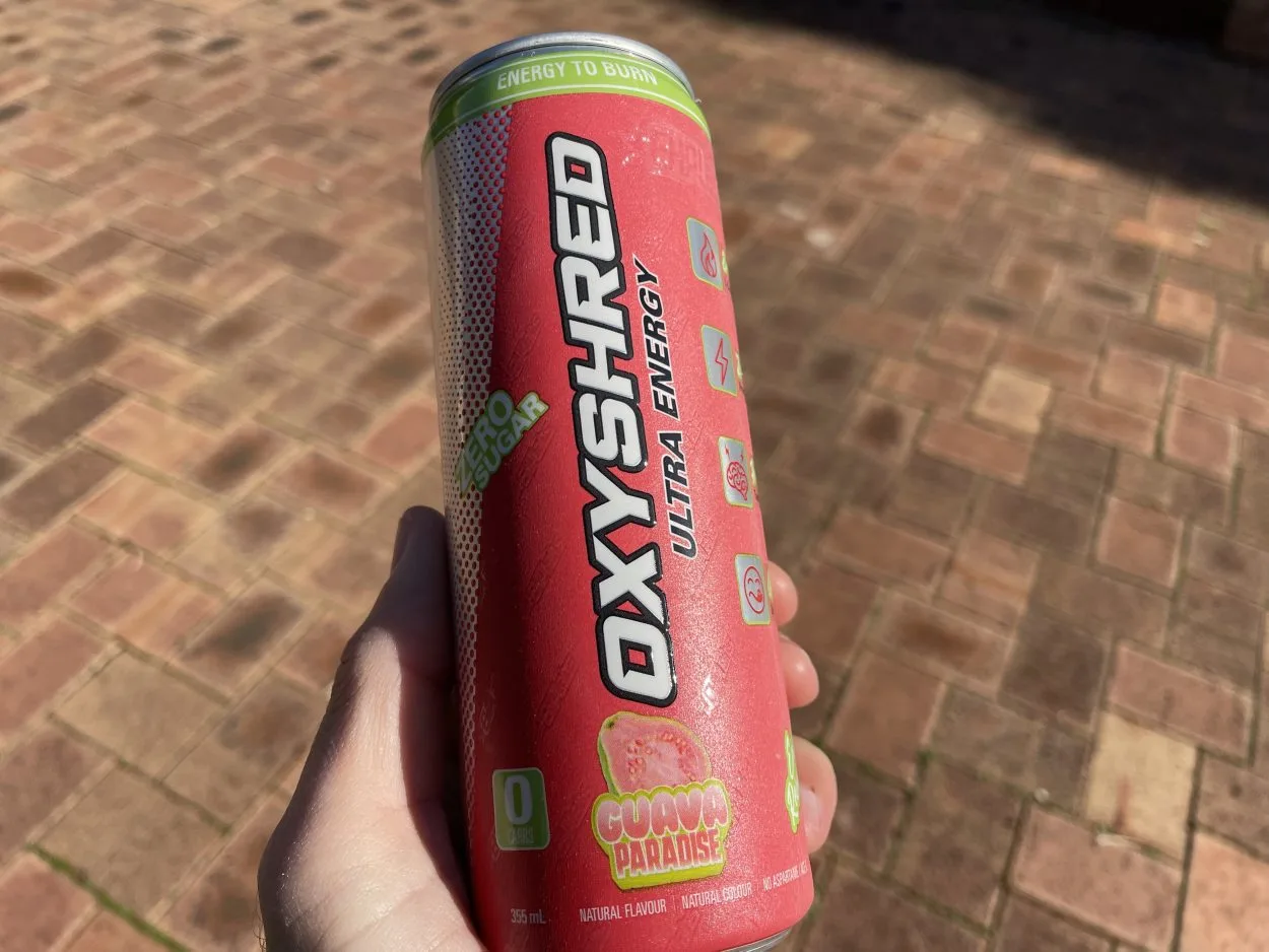 A person holding a can of OxyShred