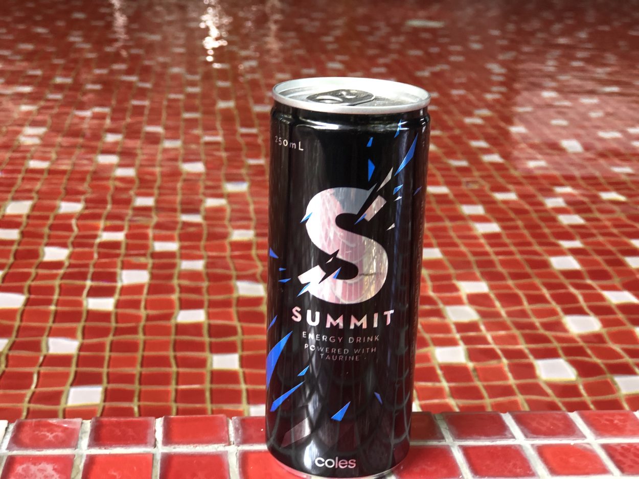 A can of Summit energy drink placed on red colored surface