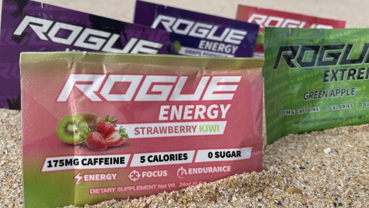 Sachets of Rogue energy powder in different flavor on sand