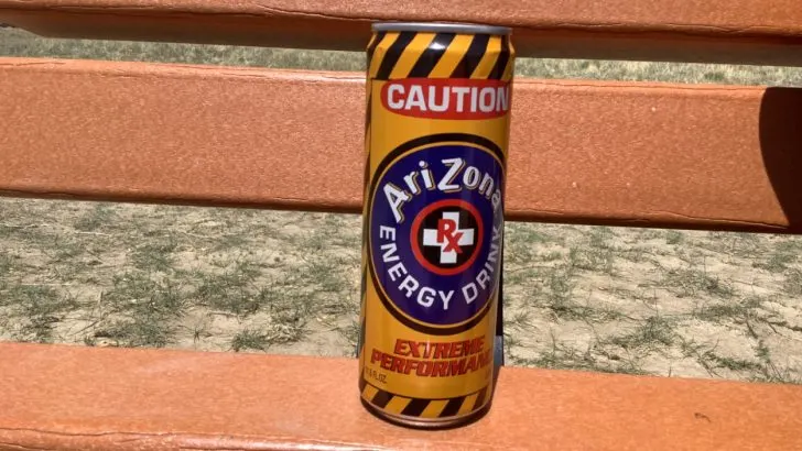 A can of Arizona energy drink placed on orange surface
