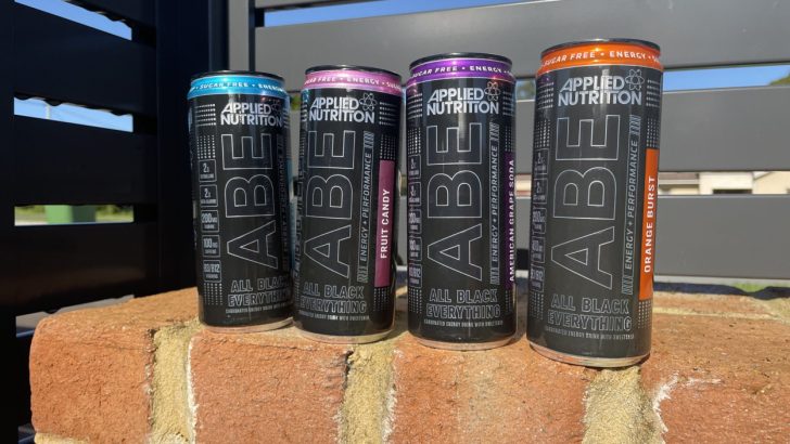 All four flavors of ABE energy drink placed on a brick wall